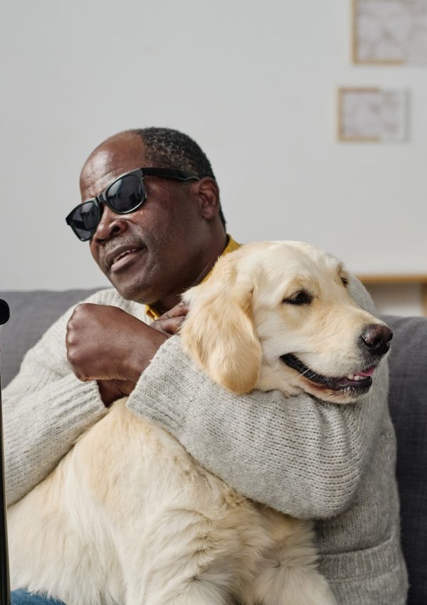 Blind man sitting with guide dog Blind man sitting with guide dog